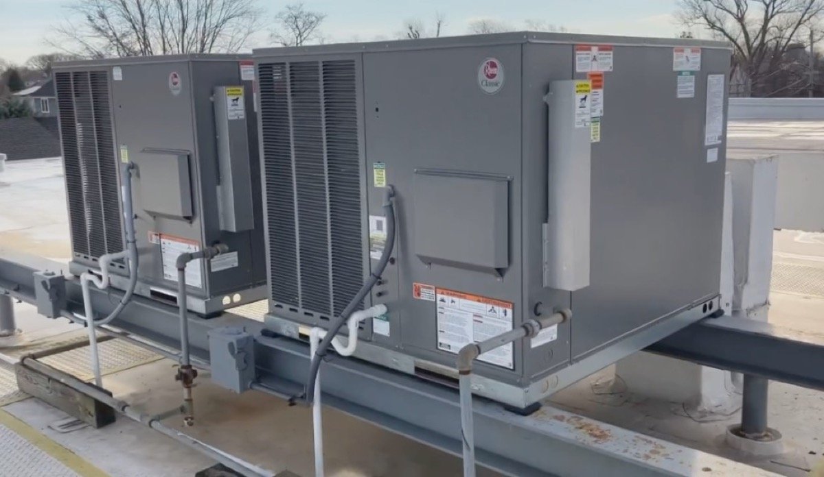 Dual Rheem Classic commercial rooftop HVAC units on a flat roof