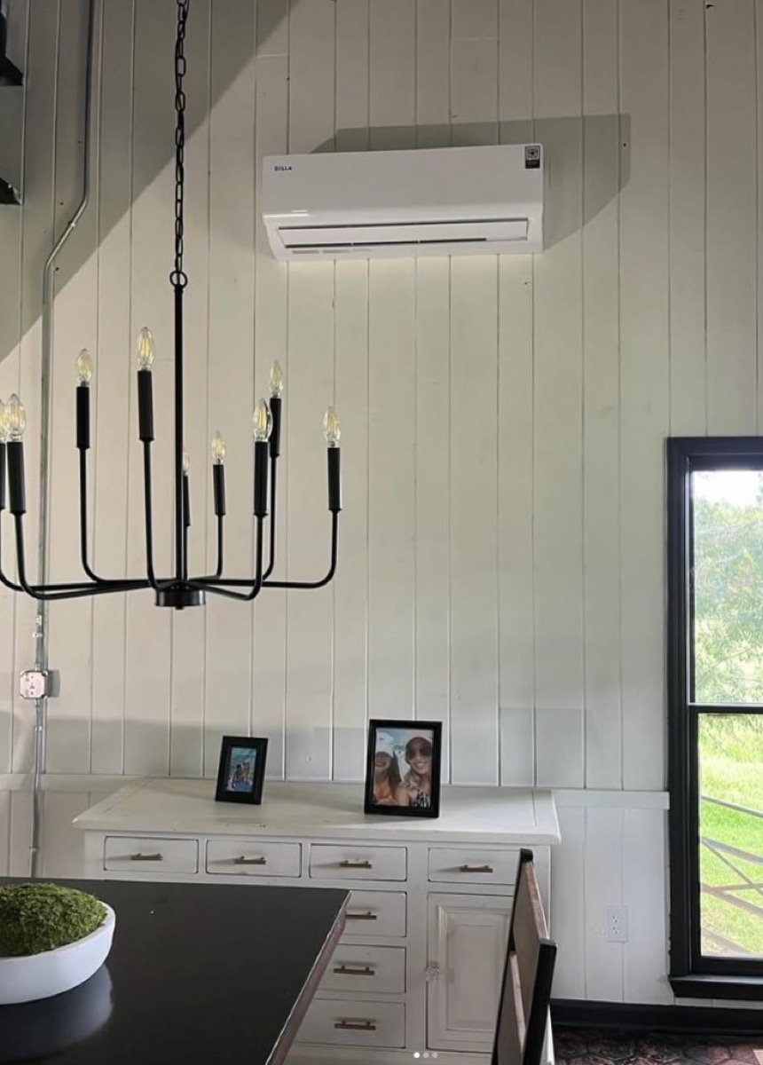 Wall-mounted ductless mini-split installed on white shiplap wall